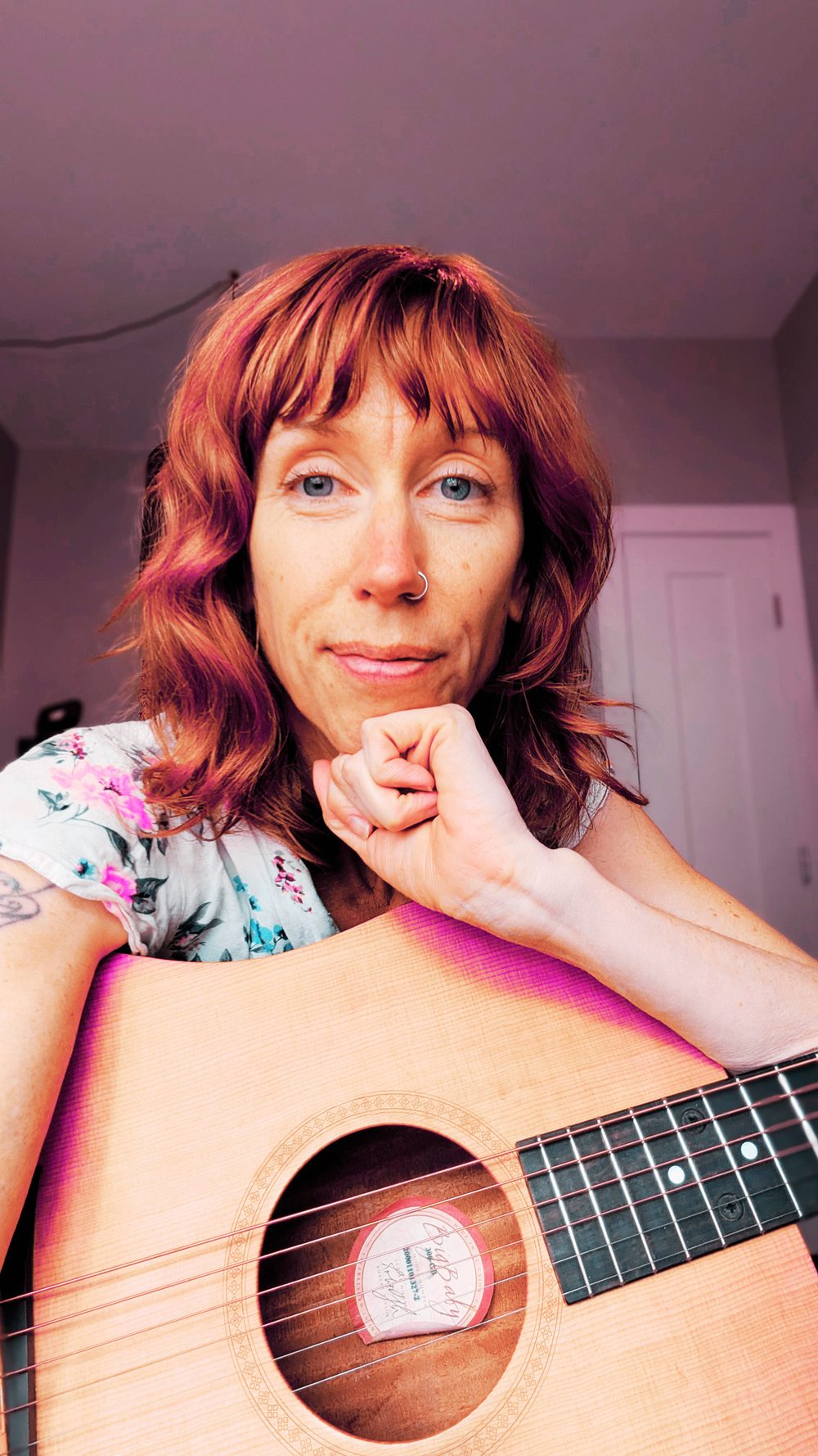 Lara Kehler holding an acoustic guitar